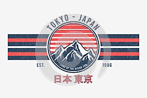 Tokyo, Japan t-shirt design with mountains and sun. Tee shirt graphics print with stripes, grunge and inscription in Japanese photo